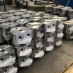 Stacked metallic mounting parts with flanges on factory floor