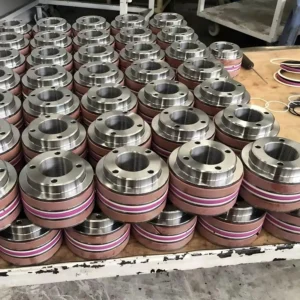 Stacked cylindrical mounting parts with pink bands in warehouse