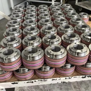 Multiple circular seals with pink rings on workbench