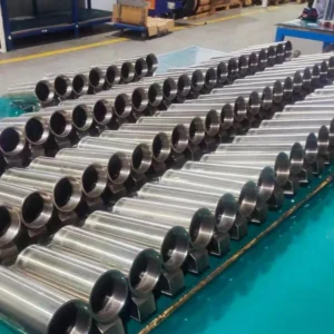Silver welded cylinders arranged in rows on factory floor