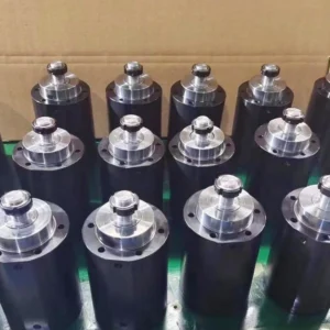 Black cylinders with flanged mounting on glass in factory