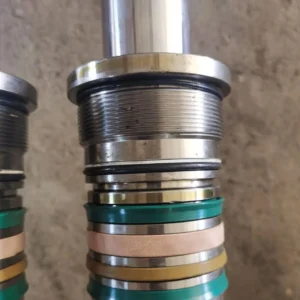 Close-up of cylindrical component with stacked seals and mounting cap