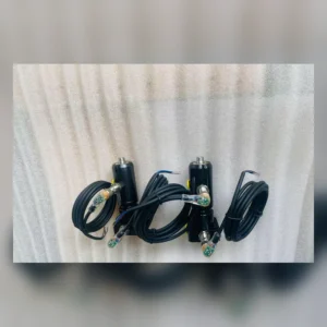 Two black sensor units with coiled cables mounted on surface.