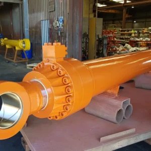 orange welded cylinder with flange on workshop platform