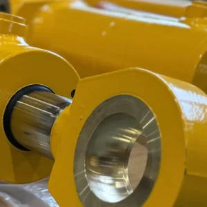 Yellow telescopic cylinders with rod ends visible on pallet