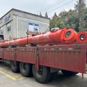 Two orange industrial cylinders on red transport trailer