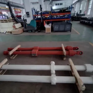 Two telescopic cylinders on factory floor with rods