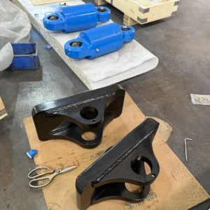 Black mounting brackets on workbench with tools