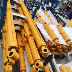 Yellow telescopic cylinders stacked in industrial storage