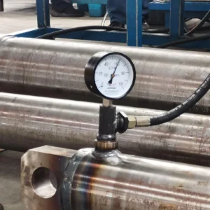 Metallic cylinder with pressure gauge in industrial testing setup