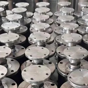 Flanged valve components stored industrially.